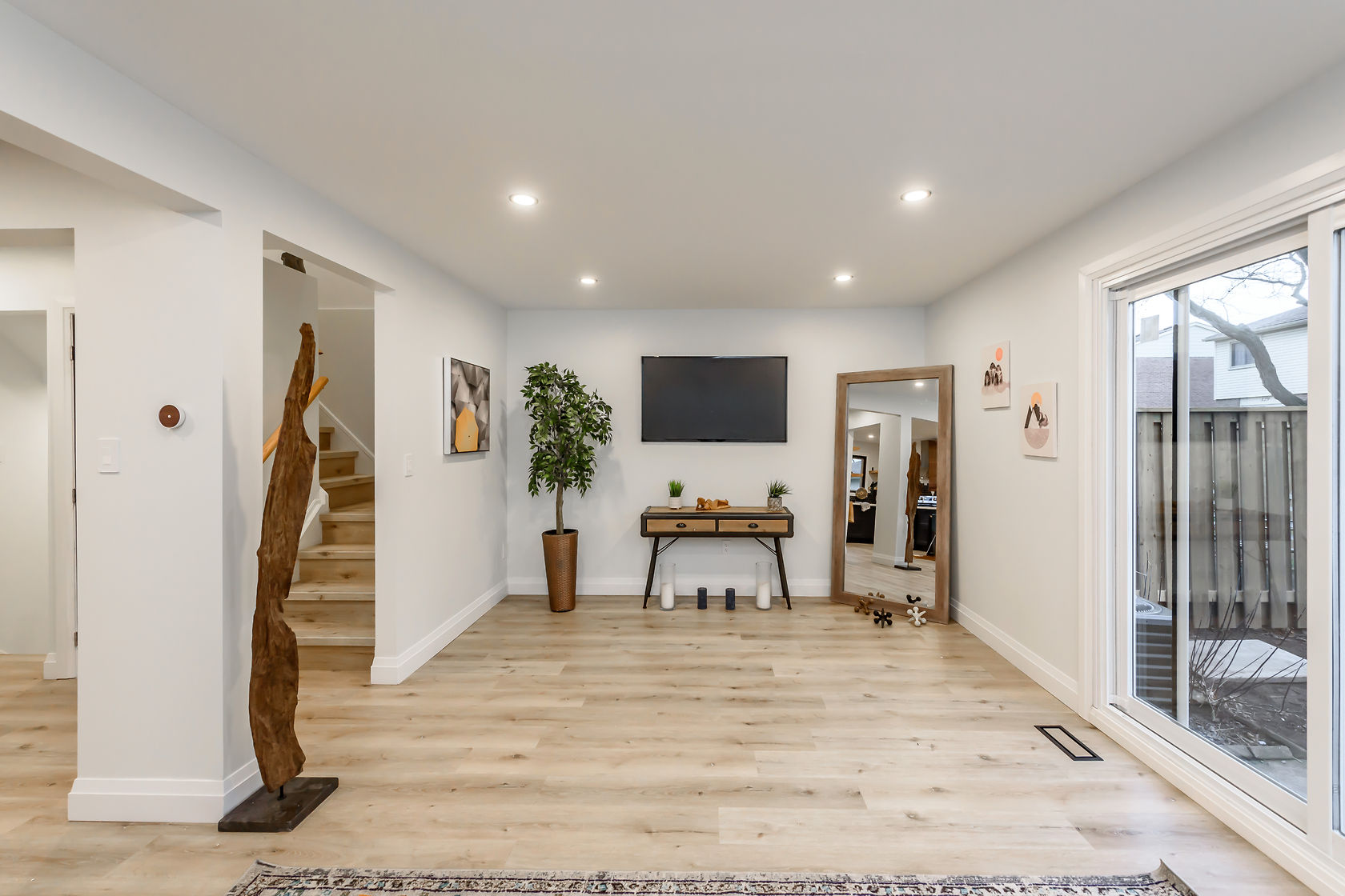 Bright finished living space with beautiful wide-plank flooring and clean modern staging — Gateshead, Hamilton | MTC Renovations